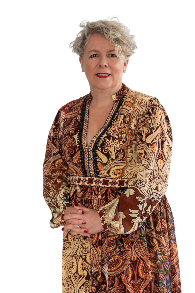 A blonde woman wearing a brown and beige paisley print dress.